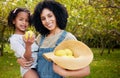 Woman with child, lemon orchard and nature, agriculture with healthy food and nutrition, portrait on citrus farm outdoor Royalty Free Stock Photo