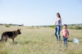 A woman with a child with German Shepherd training Royalty Free Stock Photo