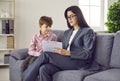 Woman child psychologist working with little boy at her office Royalty Free Stock Photo