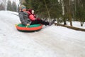 Woman with child rolling hills on a sledge in the