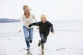 Woman and child running on beach