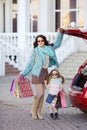 A woman with a child after shopping load the car Royalty Free Stock Photo