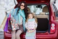 A woman with a child after shopping load the car Royalty Free Stock Photo