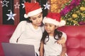 Woman and child shopping online at Christmas time Royalty Free Stock Photo