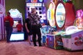 Woman and child standing by a game machine inside the Lider indoor playground. Royalty Free Stock Photo