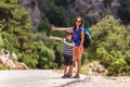 A woman with a child stop the car on the road, a hitchhiker with children