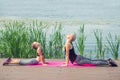 Woman and child are training near the lake on a pier Royalty Free Stock Photo