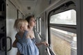 Woman with child travels by train. Family travels on the train and looks through the window. Travel by railway