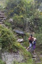 Woman with Child Walking Down Mountain