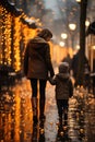 A woman and child walking down a snowy street at night