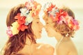 Woman and child wearing hawaiian flowers garland