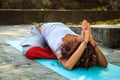 Woman in childe pose balasana outdoor autumn day