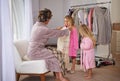 Woman, children and clothes dress up helping for fashion outfit in morning for bonding, wardrobe or preparation Royalty Free Stock Photo