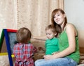 Woman and children draws on blackboard