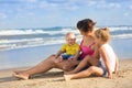 Woman with children playing on the beach Royalty Free Stock Photo