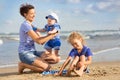 Woman with children playing on the beach Royalty Free Stock Photo