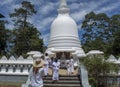 Woman and children in uniform on the stairs at white buddhist stupa building located in Nuwara Eliya town Royalty Free Stock Photo
