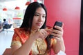 Woman, Chinese dress and mobile phone