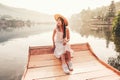 Woman with Chinese style boat in the lake with morning light and fog Royalty Free Stock Photo