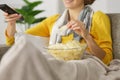 woman with chips while watching tv