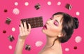 Woman and chocolate. Beautiful young woman is eating chocolate Royalty Free Stock Photo