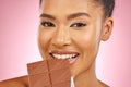 Woman, chocolate and bite in studio portrait with smile, eating and skin glow for beauty by pink background. Girl, model