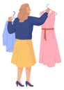 Woman choose dress in boutique. Clothing store shopping Royalty Free Stock Photo