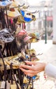 Woman chooses a carnival mask in a souvenir shop in Venice, female hand closeup