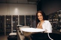 Woman chooses a ceramic sink in a hardware supermarket