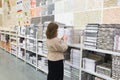 woman chooses a ceramic tile in a store Royalty Free Stock Photo