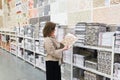 woman chooses a ceramic tile in a store Royalty Free Stock Photo