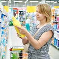 Woman chooses cleaning products in supermarket Royalty Free Stock Photo