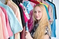 Woman chooses clothes in the wardrobe closet