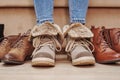 Woman chooses comfortable shoes among a bunch of different pairs