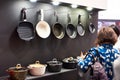 Woman chooses pans in store household goods Royalty Free Stock Photo