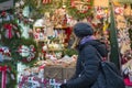 woman chooses souvenirs at the Christmas market. back view