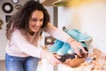 Woman chooses summer shoes at shop Royalty Free Stock Photo