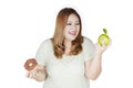 Woman choosing between apple and donut Royalty Free Stock Photo