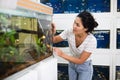 Woman choosing aquarium fish at pet shop Royalty Free Stock Photo