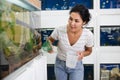 Woman choosing aquarium fish at pet shop Royalty Free Stock Photo