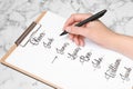 Woman choosing baby name at white marble table, closeup Royalty Free Stock Photo