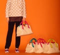 Woman choosing the bag from many bags.Isolated on green background. Shopping addiction Royalty Free Stock Photo