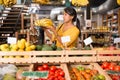 Woman choosing bananas in fruit and vegetable section of supermarket Royalty Free Stock Photo