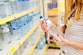 Woman choosing bottled mineral water Royalty Free Stock Photo