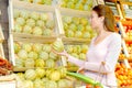 Woman choosing cantaloups