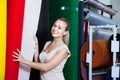 Woman choosing carpet in housewares hypermarket