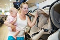 Woman choosing child car seat Royalty Free Stock Photo