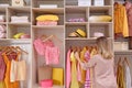 Woman choosing clothes from large wardrobe