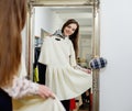 Woman choosing clothes in a showroom Royalty Free Stock Photo