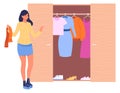 Woman choosing clothes from wardrobe closet. Home storage